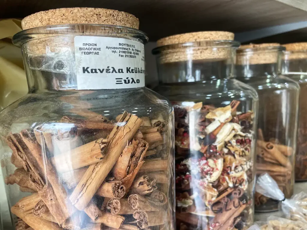 Glass jars with cinnamon on a shelve inside a traditional Corfu spice shop